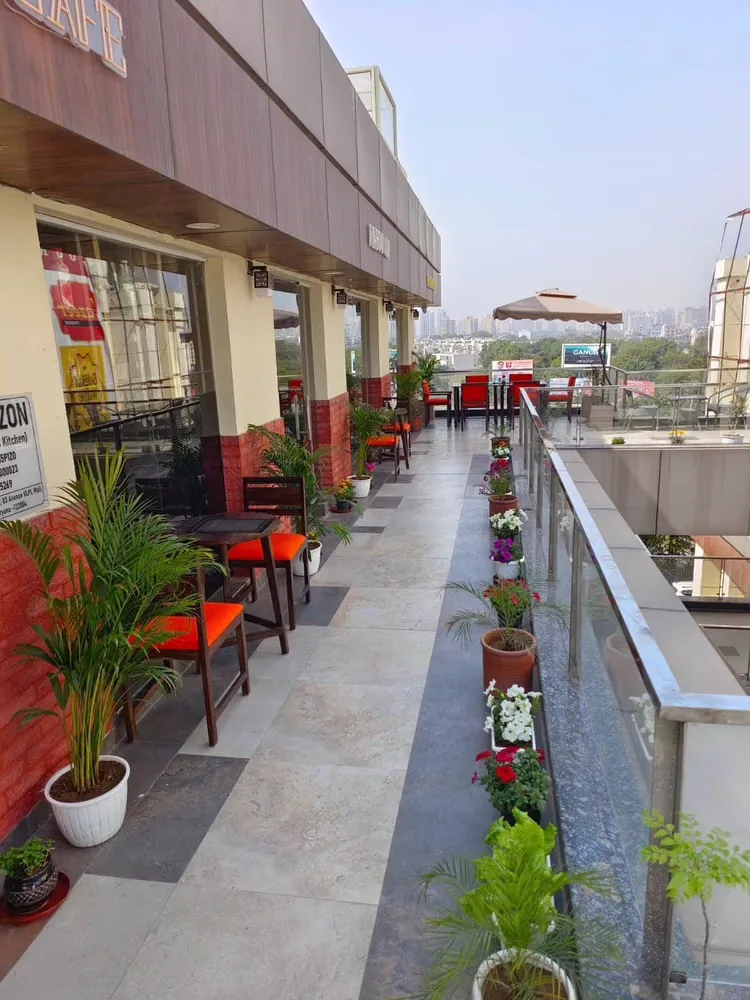 Terrace walkway lined with potted plants and flowers at dusk