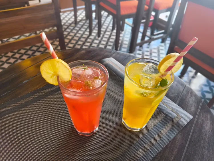 Red and yellow fruit coolers on a terrace table