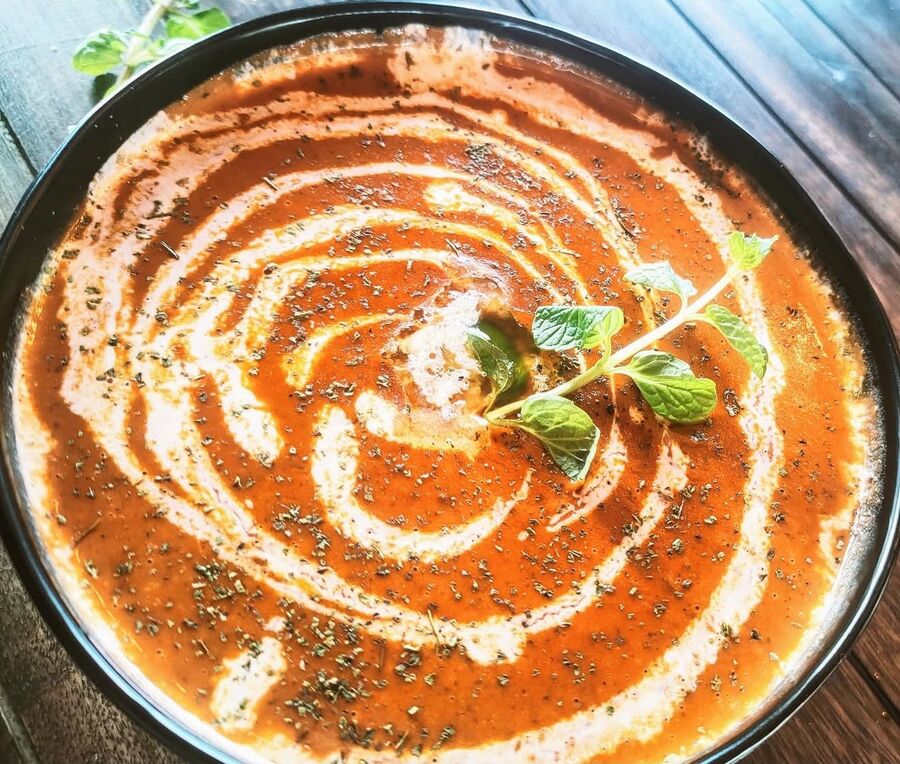 Makhni dal swirled with cream in a black bowl