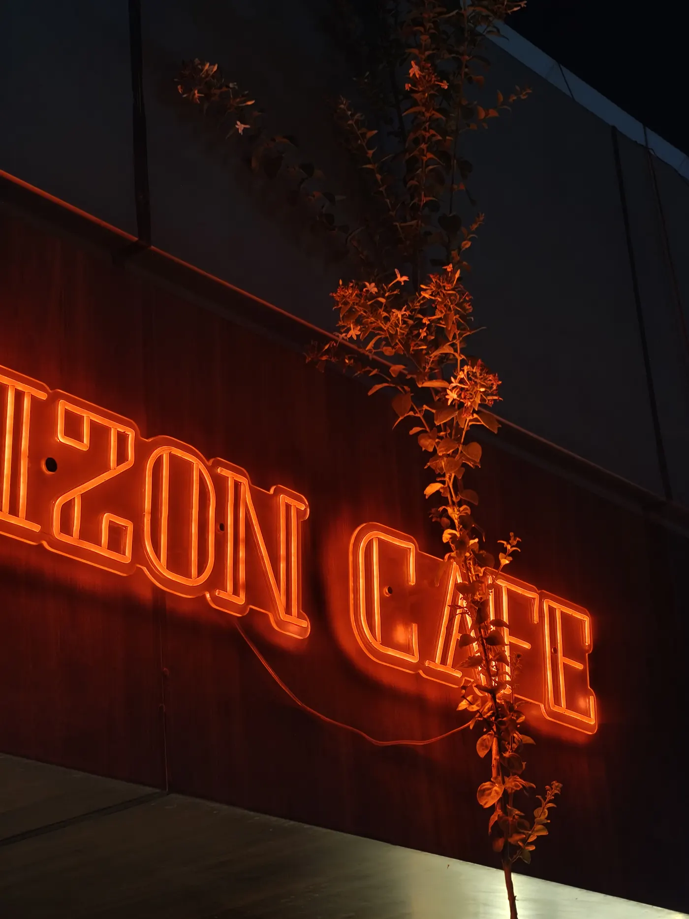 The Horizon Cafe sign glowing orange at night