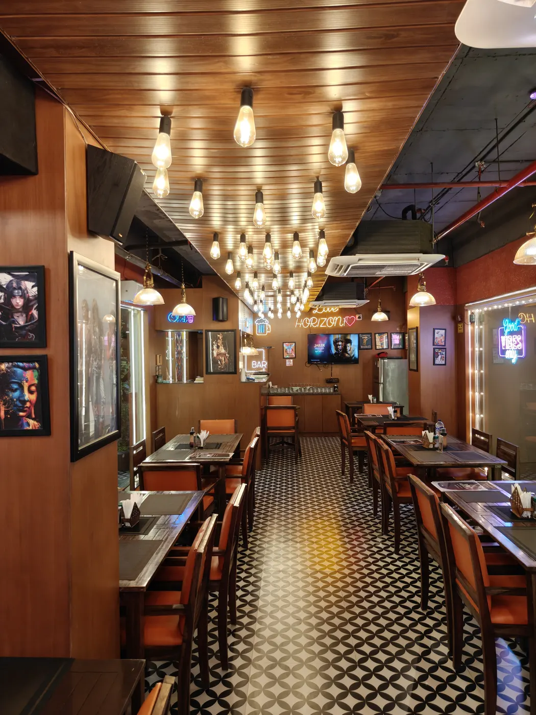 Dining tables under a ceiling of Edison bulbs